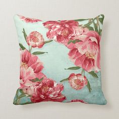 a blue pillow with pink flowers on it