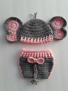 two crocheted hats and diaper covers with ears on the top one has a pink bow