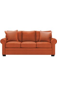 an orange couch with two pillows on it and one pillow is folded over the back