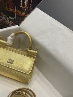 Description D.G Small Sicily Bag In Dauphine Gold For Women 7.5in/19cm DG Rep 1:1 Size: 19 x 13 x 6 cm / 7.5 x 5.1 x 2.3 inches (Length x Width x Height) Front flap with hidden magnetic fastening Branded plate featuring two metal plating finishes Top handle and adjustable, detachable strap in Dauphine Printed fabric lining and flat pocket Item comes with a branded dust bag Includes box, dust bag. This product is of the best quality.