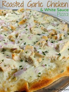 a pizza sitting on top of a pan covered in cheese and toppings with the words roasted garlic chicken & white sauce