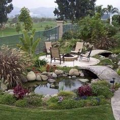 a patio with chairs and a pond in the middle