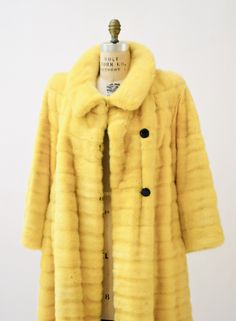 "Stunning 90s Glam Mink Fur Coat from 1992 Neiman Marcus by SORBARA! * Constructed in dyed mink in a gorgeous rich yellow ready to brighten your wardrobe * Sheared grooved mink fur * Notched collar * Large button closure * Slightly extended shoulders as the early 90s did * Aline drape style * Fully lined with black lining * Side pockets * Absolute perfection, over $10,000 in 1992! FUR: SHEARED & GROOVED DYED FEMALE MINK FURRIER: SORBARA FURS FOR NEIMAN MARCUS Great vintage condition Bust 46\ Classic Yellow Outerwear For Winter, Classic Yellow Long Sleeve Outerwear, Fitted Vintage Yellow Outerwear, Yellow Fur Coat, Vintage Fitted Yellow Outerwear, Vintage Leather Motorcycle Jacket, Luxury Vintage Mink Outerwear, Vintage Mink Fur Coat, Classic Mink-colored Faux Fur Coat