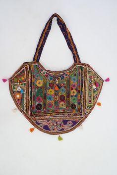 This gorgeous Indian Jaipuri Morral is perfect to style with any outfit! It is completely hand-embroidered and made on a waist loom, These beautiful bags are handmade by Indian artisans in Jaipur, Rajasthan. Material - 100% Cotton Fabric, The bag closes with a High-Quality zipper. Our bags are strictly produced by our skilled team with the natural traditional way of craftsmanship. A Perfect Shoulder Bag / Hobo Bag / Tote Bag / Hand Bag to give to an elegant look. This is the perfect gift for all Traditional Handmade Multicolor Hobo Bag, Bohemian Potli Bag With Multicolor Embroidery And Handwork, Traditional Handmade Bags For Navratri, Bohemian Multicolor Potli Bag For Festival, Bohemian Multicolor Potli Bag For Everyday Use, Bohemian Embroidered Multicolor Potli Bag, Traditional Handmade Hobo Tote Bag, Multicolor Embroidered Potli Bag For Festivals, Traditional Handmade Multicolor Embroidered Hobo Bag