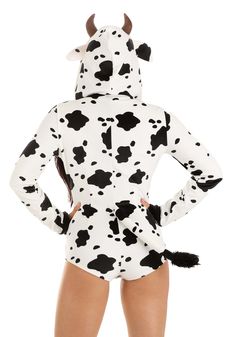 a woman wearing a cow costume with long sleeves and black spots on her body, back view