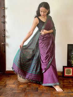 PRODUCT DETAILS: This is a one-of-a-kind saree in the soft combination of Ahimsa silk and cotton. The saree has been painstakingly woven by hand by artisans in Assam in Northeast India. Our sarees, crafted with exquisite craftsmanship and rich, vibrant colors, are perfect for Diwali, Durga Puja, Navratri, and more. Featuring intricate hand weaves, the softest fabrics, and traditional patterns, each saree embodies the essence of festivity and elegance. There may be loose threads on the backside of pallu of saree or uneven threads along the selvedge and may have slight variations in the weave as a result of its handmade features. Please note that this is a characteristic of a genuine handloom product.  The saree has been woven on traditional handlooms by artisans in rural Assam. > Total sare Purple Handloom Pre-draped Saree For Puja, Bollywood Style Purple Handloom Pre-draped Saree, Purple Handloom Chanderi Pre-draped Saree, Purple Handloom Pre-draped Saree For Diwali, Purple Cotton Silk Saree With Cutdana, Navratri Purple Pre-draped Saree, Festive Purple Cotton Silk Saree, Purple Bollywood Cotton Silk Saree, Purple Cotton Silk Saree Traditional Drape