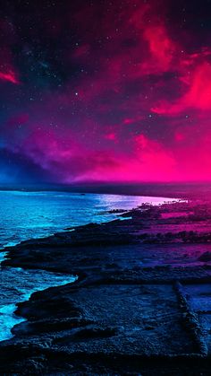 the sky is full of stars and clouds over the water at night time, with waves crashing on the shore