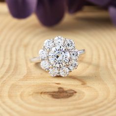 a diamond ring sitting on top of a wooden table