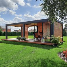 a small house sitting on top of a lush green field