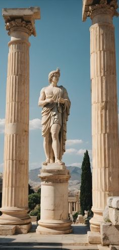 the statue is standing between two large pillars