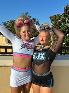 two cheerleaders are posing for the camera