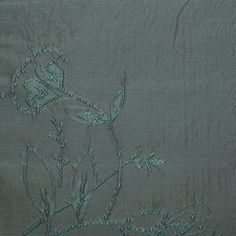 an embroidered piece of cloth with flowers on it