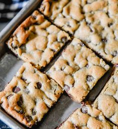 chocolate chip cookie bars cut into squares on a baking sheet, ready to be eaten