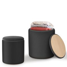 an ottoman and stool with clothes on top