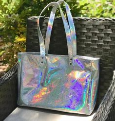 Large Holographic Leather Tote Handmade in Australia - Smooth soft holo leather - shown with gunmetal hardware and Lining 4 inside: Magnetic closure or choose zipper close 3 slip pockets Swivel clasp for keys Outside: - Strong Flat Shoulder Straps, stitched and riveted. Length 69cm. - Metal feet on bottom Size: Length: 40cm (15.7 inch) Depth: 10cm (3.9 inch) Height: 28cm (11 inch) * An everyday bag, fitting everything you need. * Fully lined in your choice of quality lining fabric (see options) Iridescent Rectangular Travel Bag, Trendy Iridescent Bag For Everyday Use, Iridescent Trendy Bag For Everyday Use, Trendy Iridescent Bags For Everyday Use, Iridescent Rectangular Shopping Bag, Gunmetal Hardware, Oversized Tote, Leather Zipper, Everyday Bag