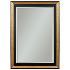 a black and gold framed mirror on a white wall