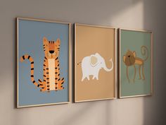 three framed pictures of animals hanging on the wall