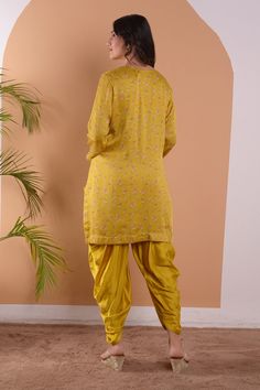 Yellow modal satin kurta with floral print& hand embroidered neck in sequin and beads work. Paired with cowl draped dhoti pants.
Components:2
Pattern:Printed &Embroidered
Type of Work:Floral, Sequin and Beads Work
Neckline:Notched Round
Sleeve Type:Full Sleeves
Fabric:Modal Satin
Color:Yellow
Other Details:
Scalloped hem
Side slits on kurta
Note: The potli bag carried by the model is not for sale
Occasion:Sangeet,Haldi and Mehendi - Aza Fashions Navratri Semi-stitched Pant Set With Pallu, Traditional Harem Salwar Kameez For Festivals, Traditional Saree Pant Set With Pallu, Unstitched Pant Set With Pallu For Diwali, Diwali Chanderi Set With Traditional Drape, Diwali Chanderi Set In Traditional Drape, Traditional Pant Set With Dabka And Traditional Drape, Fitted Palazzo Set For Puja With Traditional Drape, Semi-stitched Traditional Pant Set For Festivals