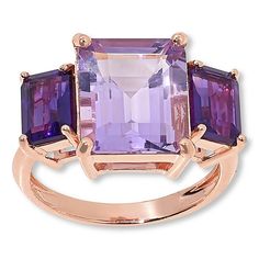 Elevate your style with the Colleen Lopez 3-Stone Emerald-Cut Gemstone Ring, a piece that combines elegance with a splash of color. This exquisite ring features three emerald-cut gemstones, beautifully coordinated in African Amethyst and Pink Amethyst, set in a rose gold-plated band.

- **Size:** 7
- **Material:** Sterling silver, rose gold-plated
- **Color:** African Amethyst (purple), Pink Amethyst (pink)
- **Dimensions:** Approx. 7/16"L x 3/4"W x 1/4"H; shank 1/16"W
- **Total Carat Weight:** Amethyst Set, Peridot Green, Sky Blue Topaz, Green Peridot, Amethyst Purple, Swiss Blue Topaz, Pink Amethyst, Amethyst Gemstone, Purple Amethyst