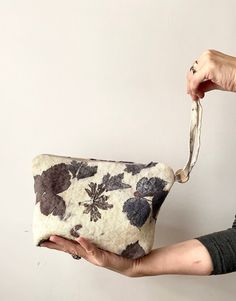 a woman is holding an old purse in her hand