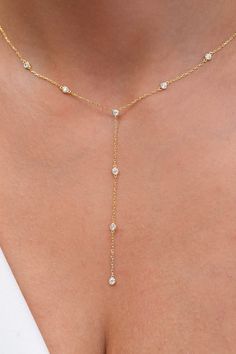 This beautiful 14k solid gold lariat necklace has 8 wrapped diamond bezels. Wear this by itself or layer it with another one of your favorite pieces. Alternatively, choose from our options of natural diamonds and sustainable lab-grown diamonds at two different price points to fit your unique preferences and budget. Please check below to see specifications of each stone option. Each piece is accompanied by an Azalea Certification and Warranty document, ensuring that you receive a high-quality, authentic piece of fine jewelry. Please message us if you don't receive your certification with your piece. M A T E R I A L & L E N G T H Available in 14k Yellow Gold, 14k Rose Gold, 14k White Gold Stone: 8 Round Natural Diamonds Diamond Size: 2.3 mm Carat Weight: 0.40 ct. tw. Chain: Link Chain Chain Lariat Diamond Necklace, Layered Diamond Necklace, Diamond Lariat Necklace, Diamond Statement Necklace, Diamond Drop Necklace, Gold Lariat Necklace, Necklace Bridal, Gold Diamond Jewelry, Necklace Diamond