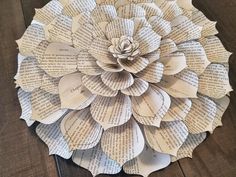 a paper flower made out of old book pages