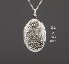 "Carrying the pictures of your loved ones close to your heart all the time, this large oval sterling silver locket necklace features: 1. a large (30 x 21 mm without bale, 7.5 grams), both sides stamped with an ornate daisies (April birth flower)      3. It can hold two pictures inside. Photo insertion service is available for $14 each (selected through the pulldown menu). If you decide to use this service, please attach your locket photos to a conversation.  4. a sterling silver cable chain with Sterling Silver Locket Necklace With Oval Link For Gifts, Oval White Gold Locket Necklace For Keepsake, White Gold Oval Locket Necklace For Keepsake, Oval White Gold Locket Necklace Keepsake, Heirloom Silver Locket Necklace With Oval Pendant, Oval Pendant Locket Necklace With Engraving Option, Silver Oval Locket Necklace Keepsake, Engraved Sterling Silver Locket Necklace With Oval Pendant, Silver Oval Link Locket Necklace Keepsake