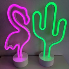 two neon lights that are shaped like cactuses