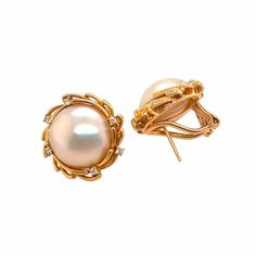 This is part of Chairish’s Fine Jewelry assortment.  A fine pair of vintage 14K gold Mabe pearl and diamond earrings. The earrings are Marked 14K and 585. The Mabe pearls are surrounded with an openwork bezel accented by 6 very tiny prong set diamonds. They have Omega pierced clip earrings. Condition is excellent.  Dimensions: Diameter: 17mm; Pearl diameter: 12mm: Weight: 10.8 grams Elegant Formal Clip-on Diamond Earrings, Elegant Hallmarked Diamond Clip-on Earrings, Classic Yellow Gold Diamond Earrings For Evening, Elegant Yellow Gold Clip-on Diamond Earrings, Timeless Diamond Pearl Earrings For Evening, Elegant Formal Clip-on Earrings With Diamond Accents, Wedding Yellow Gold Clip-on Diamond Earrings, Formal Gold Diamond Earrings, Luxury Gold Pearl Earrings With Diamond Accents