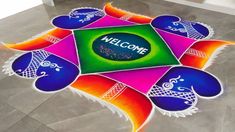 a colorful welcome sign is on the floor