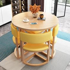 a round table with yellow chairs around it in a room next to a blue rug