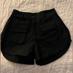 Black High Waisted Shorts. Never Worn. Small Pockets On Front And Back. Super Cute. Has Fabric Detailing On The Sides Also. Tag Says They Are A Large But That Is Definitely Wrong. I’m A Size 4 And They Only Just Barely Would Fit. Black High-waist Shorts With Pockets, Black Bottoms With Pockets For Day Out, Black Shorts With Pockets For Summer, Trendy Black Shorts With Pockets, Summer Black Shorts With Pockets, Black Summer Bottoms With Pockets, Black Short Summer Bottoms, Summer Black Short Bottoms, Trendy Black Shorts For Vacation