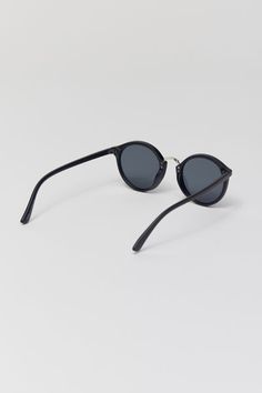 Round silhouette sunglasses with a plastic frame. Features a metal nose piece and temple accents. Fitted with tinted UV-blocking lenses. Features Plastic frame sunglasses Metal accents Tinted UV-blocking lenses Content + Care Polycarbonate, metal Wipe clean Imported Size Bridge: 20mm Width: 50mm Height: 46mm | Myrtle Round Sunglasses in Black, Men's at Urban Outfitters Classic Plastic Sunglasses With Uva Protection, Classic Plastic Sunglasses With Anti-reflective Coating, Classic Sunglasses With Uv Protection, Mirrored Lenses Round Frame Sunglasses With Adjustable Fit, Adjustable Round Frame Sunglasses With Mirrored Lenses, Mirrored Round Frame Sunglasses, Black Sunglasses With Tinted Round Frame, Round Frame Sunglasses With Tinted Glass Lenses, Adjustable Round Frame Tinted Sunglasses