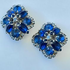 Faux Blue Sapphire Clip on earrings  Blue Rhinestones  Silver tone metal  Please see pictures for size and dtetails Blue Metal Earrings With Rhinestones, Blue Metal Clip-on Jewelry, Blue Jeweled Metal Earrings, Blue Metal Clip-on Earrings, Formal Jeweled Blue Earrings, Blue Jeweled Crystal Earrings, Blue Jeweled Earrings For Wedding, Formal Blue Metal Earrings, Blue Costume Jewelry Wedding Earrings