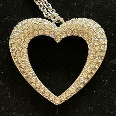 A Flared Silver Heart Is Encrusted In Glassy White Rhinestones, Resulting In A Romantic Shimmer At The Bottom Of An Extended Silver Chain. Never Worn. Valentine's Day Party Crystal Heart Necklace, Silver Heart-shaped Necklace With Rhinestones, Elegant Rhinestone Crystal Necklace With Heart Pendant, Elegant Crystal Rhinestone Heart Pendant Necklace, Crystal Necklaces With Bling For Valentine's Day, Elegant Crystal Heart Pendant Rhinestone Necklace, Heart-shaped Rhinestone Party Jewelry, Crystal Necklace With Bling For Valentine's Day, Elegant Heart Necklace With Rhinestones For Parties