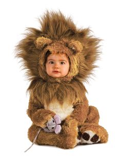 a baby dressed in a lion costume sitting on the ground with its head turned to the side