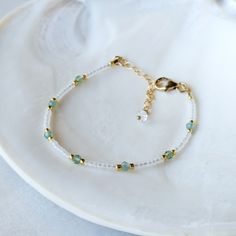 Like the clear teal waters of a tropical destination - this *rare* Aqua Teal Green Apatite bracelet is absolutely dreamy! The Aqua Teal Green Apatite gemstones have the most captivating transparent teal color to them. And they are not something you can find very often. They are paired with semi-transparent pearlescent glass beads for the ultimate beachy look! SHOP THE MATCHING NECKLACE! Just like water, Green Apatite has the power to purify, cleanse and calm. It is also an empowering stone of manifestation. It can give you greater inner strength, inspiration and clarity. It can help you tune in to your intuition, so that you can begin making decisions with confidence. Colors: This beaded bracelet features semi-transparent matte glass beads in the most alluring pearlescent white color Gemst Apatite Bracelet, Green Apatite, Diy Armband, Anklet Designs, Making Decisions, Diy Jewlery, Gold Alloys, Teal Color, Semi Transparent