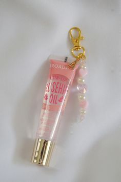 This lip gloss keychain is just the perfect accessory to personalize your beauty essentials or to gift to a friend. Attached to the lip gloss is a cute beaded charm and an initial charm of your choice.  Add this cute keychain to your keys, purse, or etc to have your lip gloss with you at all times.  D E T A I L S  - this keychain includes the lip gloss.  - Please note that due to photo editing, lighting, and screen settings, colors on the photos may be slightly different than the colors in perso Affordable Pink Glasses Chains For Gifts, Phone Key Chain, Lip Gloss Keychain Diy, Lip Gloss Charms, Lip Gloss Keychain, Lipgloss Keychain, Lipstick Keychain, Lip Balm Keychain, Birthday 12