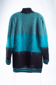 "SIZE: intended to fit size L, but may be worn by even smaller (M) and larger (XL) frames for a desired fit. MATERIAL: 75% mohair, 25% acrylic. COLOR: teal blue, green, black. FEATURES: this vintage woman's open front mohair blend cardigan is intended for an oversized fit, has padded shoulders (can be easily removed if not needed) and is fully lined what adds some windproofness. Wear open front or belted with matching belt and it will definitely make you stand out of the crowd. CONDITION: excell Green Mohair Winter Cardigan, Blue Vintage Knit Outerwear, Cozy Green Mohair Sweater, Vintage Blue Knit Cardigan, Cozy Mohair One-size Cardigan, Mohair Cardigan, Black Features, Mohair Wool, Shearling Jacket