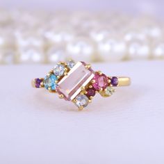 Emerald Cut Pink Sapphire Cluster Ring Multi Gemstone Engagement Ring 18K Yellow Gold Jewelry Art Deco Bridal Ring Anniversary Gift For Wife Description: Main Stone - Sapphire Stone Size - 7 x 5 MM Stone color - Pink Main Stone creation - Lab Created Stone shape - Emerald  Birthstone - September Secondary Stone - Multi Gemstone (Ruby, Aquamarine, Topaz, Amethyst) Stone Color - Multi Color Stone Shape - Round Finishing- Excellent feel free to contact me if you have any questions  Gemstone color m Elegant Multi-stone Open Birthstone Ring, Gold Multi-stone Gemstones For Wedding, Elegant Yellow Gold Rings With Stones, Morganite Topaz Ring In Yellow Gold, Elegant Multicolor Birthstone Ring In 14k Gold, Morganite Rings With Gemstone Accents, Fine Jewelry, Elegant Yellow Gold Multi-stone Crystal Ring, Elegant Multicolor 14k Gold Birthstone Ring, 14k Yellow Gold Rings With Stones