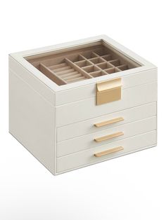 a white drawer with gold handles and drawers on the bottom, it is open to reveal a