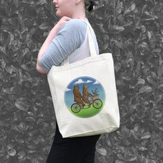 This heavy canvas shopping tote will hold multiple gifts or groceries and the full side and bottom gussets give this bag shape, even when empty. The sturdy handles make it easy to carry over the shoulder. It is a large eco-friendly bag that can be used over and over again. 10-1/2"W x 14"H x 5"D 23" Handles Bigfoot Illustration, Forest Hike, Tandem Bike, Eco Friendly Bags, Shopping Tote Bag, Shopping Tote, Pacific Northwest, Canvas Material, Some Fun