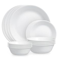 the white dishes are stacked on top of each other