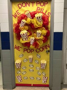 a door decorated with popcorn and decorations for a movie themed school hallway decorationating contest