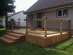 a wooden deck in front of a house