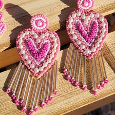 Lovely In Shape, And Finely Detailed In Beadwork, These Earrings Are A Sure Standout. Hues Of Pink, Magenta And White Are Accented By Silver. A Wonderful, Sparkling Harmony Of Colors And Form! Glass , Acrylic , Cotton Fabric & Iron Metal Valentine's Day Heart Dangle Earrings With Beads, Bohemian Heart Beads Earrings For Valentine's Day, Pink Beaded Heart Earrings For Party, Bohemian Heart Shaped Beaded Earrings, Valentine's Day Beaded Dangle Heart Earrings, Valentine's Day Heart Beaded Round Earrings, Valentine's Day Heart Beaded Dangle Earrings, Pink Beaded Heart Earrings For Valentine's Day, Heart-shaped Beaded Earrings For Party