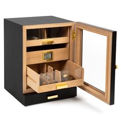 an open wooden watch box with watches in it's drawer and its reflection in the mirror