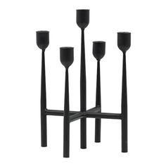 four black candlesticks sitting next to each other