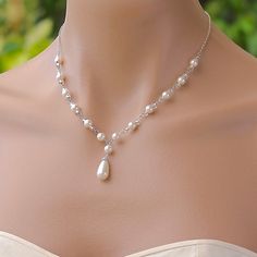 "Vanessa pearl backdrop necklace is a romantic and sweet Bridal necklace if you're a bride wanting a delicate touch to your wedding gown. Ivory White Swarovski pearls and silver lined glass beads are hand linked to create a Y necklace and completed with a rhodium chain . This style is very flattering to your décolletage and will suit most bridal necklines. Measurements: 16\" or 18\". ( 2\"extender can be added if NO backdrop is selected - Please request this at checkout) Pendant drop - 1 1/4\" ( Delicate Wedding Drop Necklace With Pearl Chain, Dainty Pearl Bridal Necklace For Wedding, Elegant Pearl White Drop Necklace For Wedding, White Pearl Necklace For Bridal Shower, White Pearl Bridal Necklace For Bridal Shower, Bridal Pearl Necklace For Wedding, Pearl Drop Necklaces For Wedding, Elegant Pearl Charm Drop Necklace For Wedding, Pearl Drop Necklace For Wedding