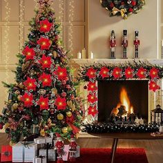 a christmas tree decorated with poinsettias and ornaments in front of a fireplace